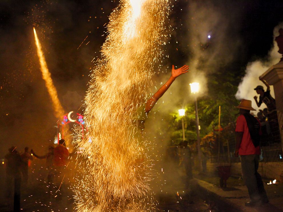 Picture of a reveler with fireworks in Cuba