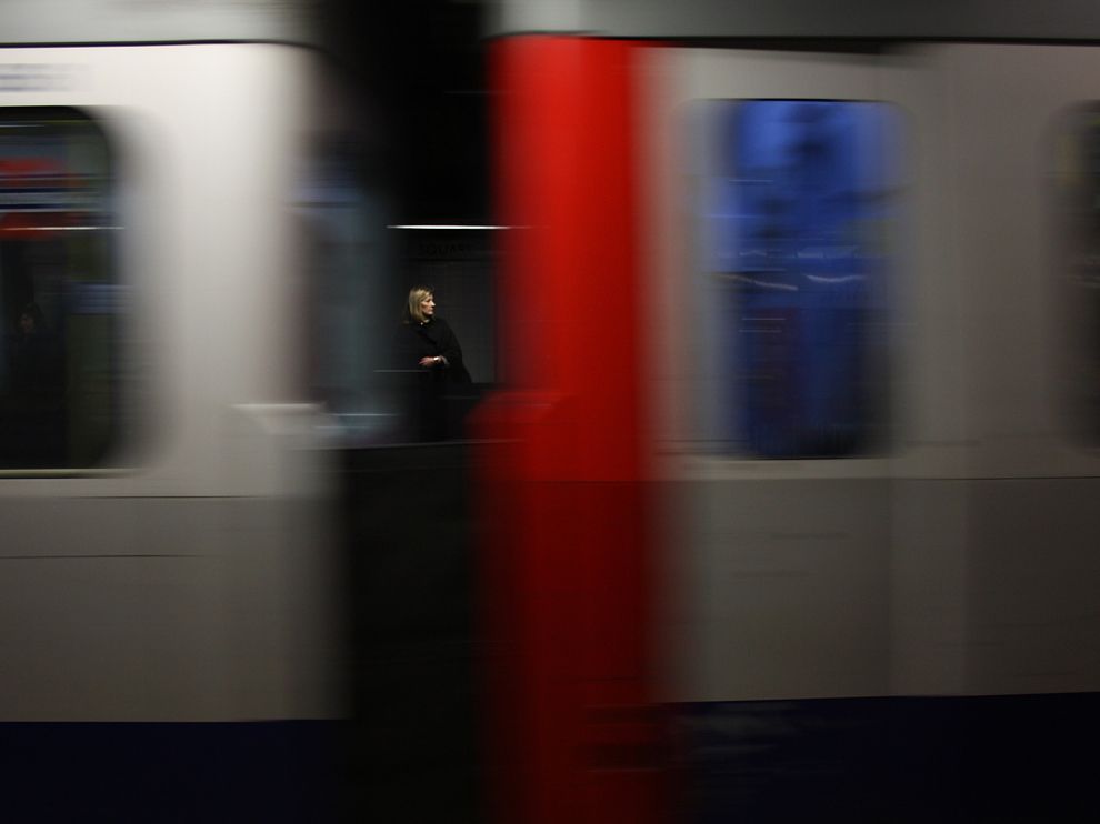 Picture of a woman seen between the cars of a passing train